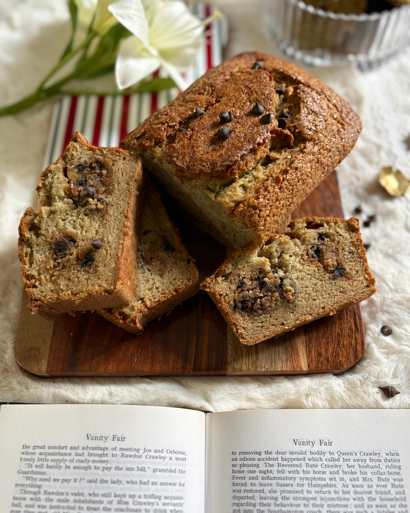 Banana Cookie Melt slices in a bowl with coffee and vintage books